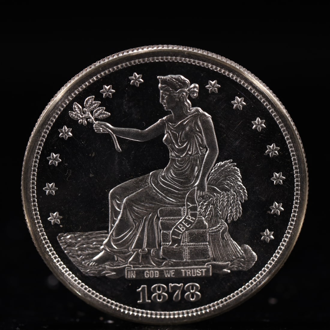 USA Trade Dollar 1878 Coin: American coin. Obverse: Liberty seated on a pedestal facing the sea to the left holding olive branches surrounded by 13 stars. IN GOD WE TRUST / LIBERTY / 1878. Reverse: An eagle holding branches with