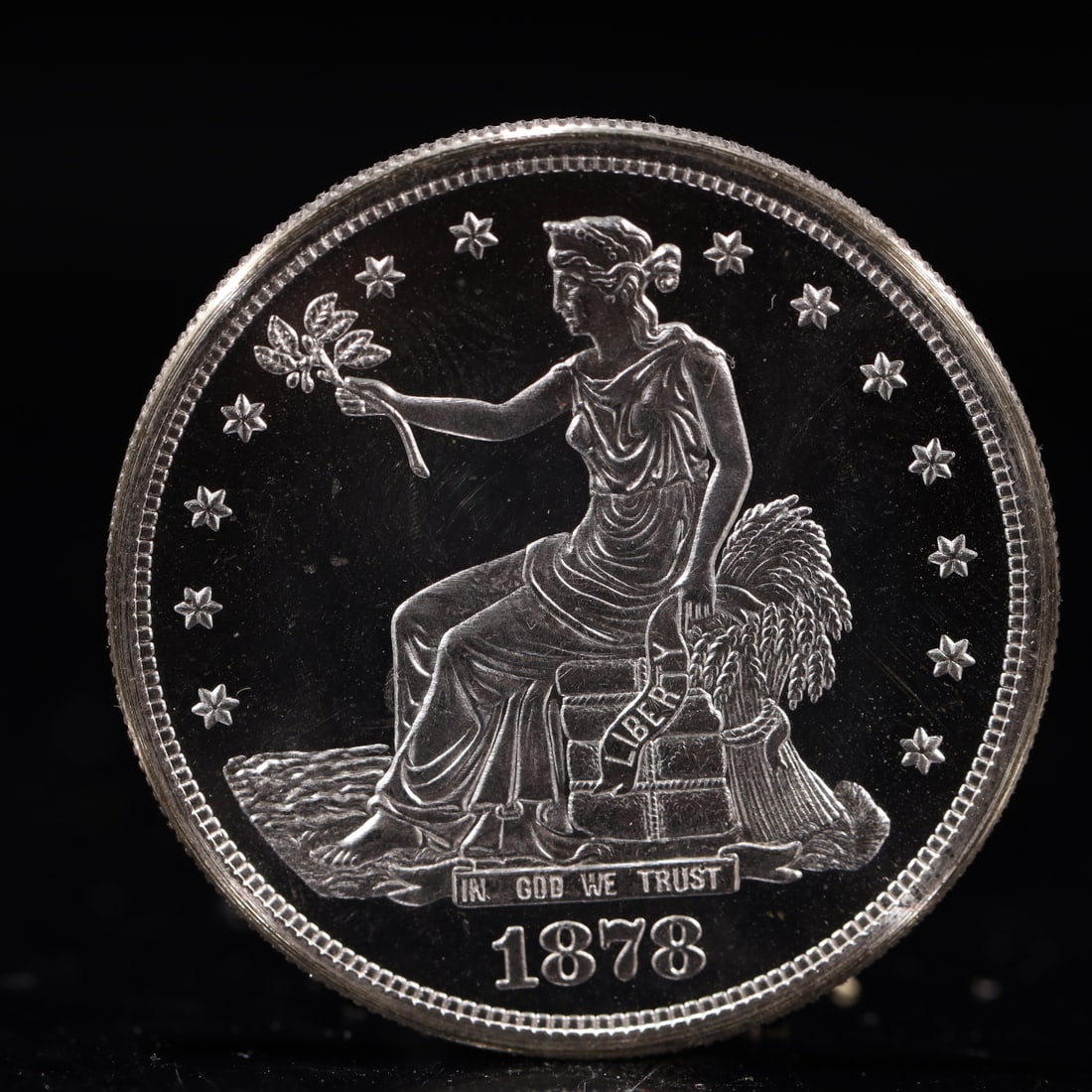 USA Trade Dollar 1878 Coin: American coin. Obverse: Liberty seated on a pedestal facing the sea to the left holding olive branches surrounded by 13 stars. IN GOD WE TRUST / LIBERTY / 1878. Reverse: An eagle holding branches with