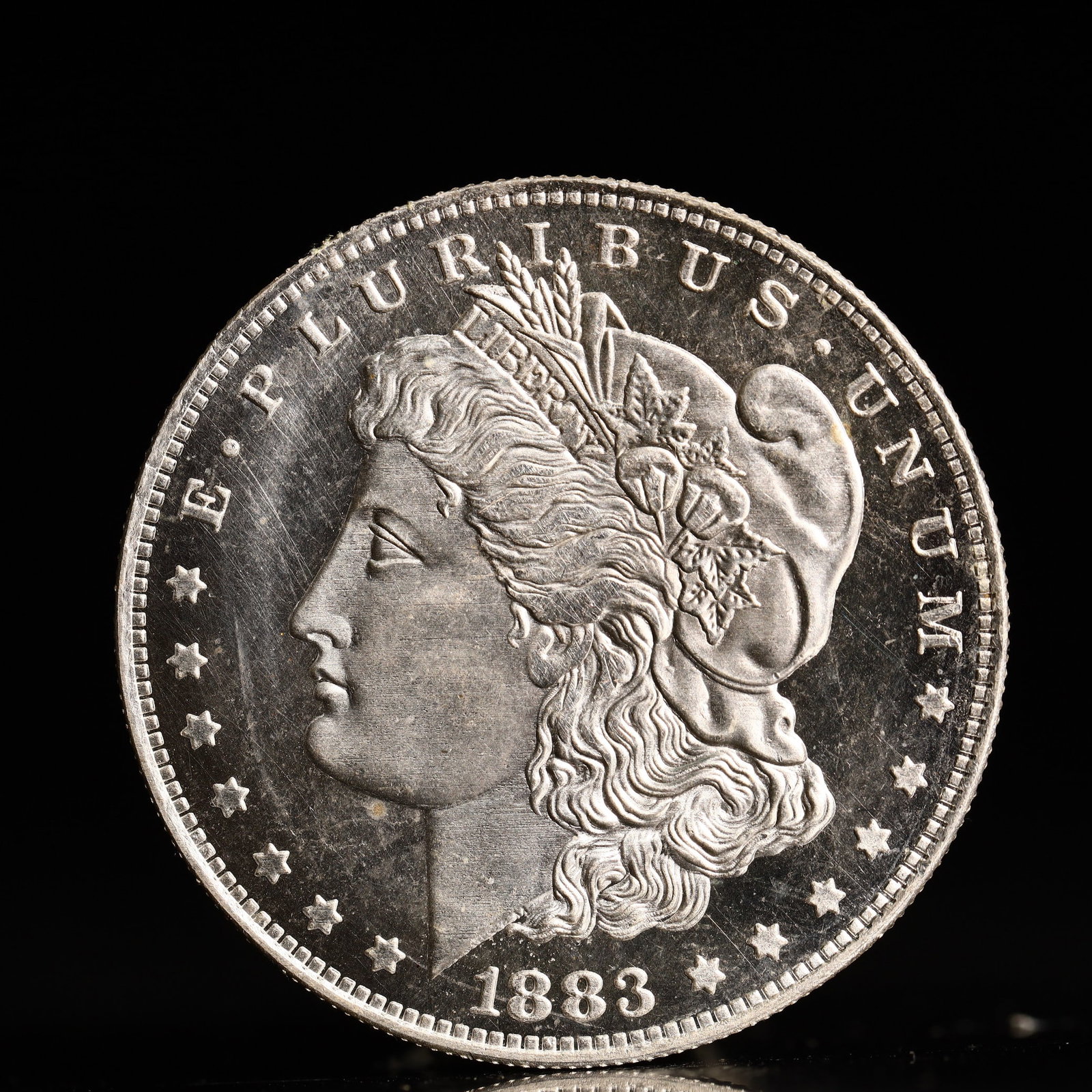 USA Morgan Dollar 1883 Coin: Obv: profile bust with date below and E PLURIBUS UNUM legend and stars around. Rev: eagle with In God we trust above within wreath with UNITED STATES OF AMERICA ONE DOLLAR legend. IN GOD WE TRUST /