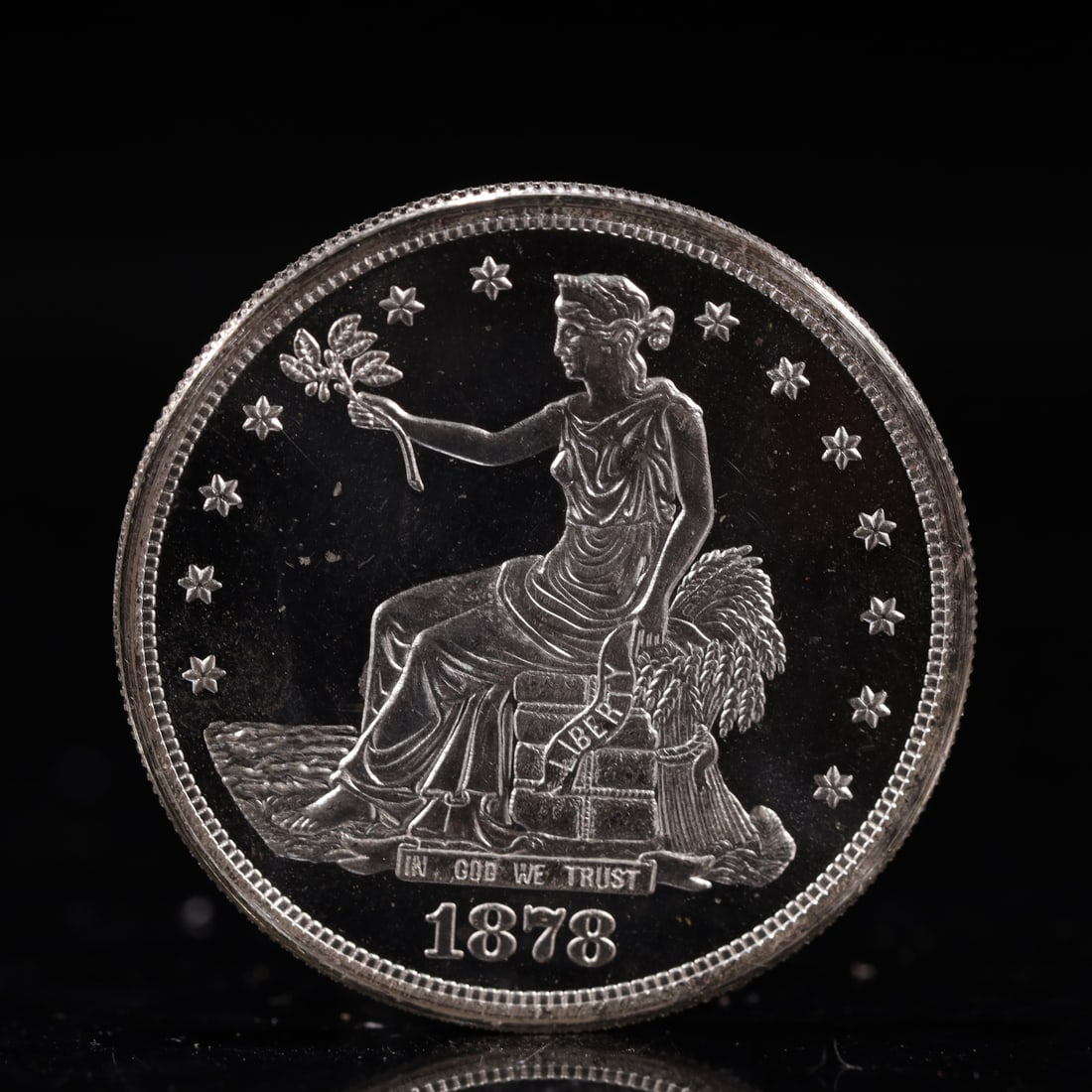 USA Trade Dollar 1878 Coin: American coin. Obverse: Liberty seated on a pedestal facing the sea to the left holding olive branches surrounded by 13 stars. IN GOD WE TRUST / LIBERTY / 1878. Reverse: An eagle holding branches with