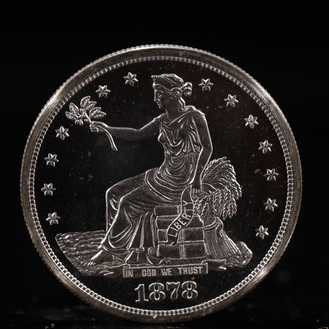 USA Trade Dollar 1878 Coin: American coin. Obverse: Liberty seated on a pedestal facing the sea to the left holding olive branches surrounded by 13 stars. IN GOD WE TRUST / LIBERTY / 1878. Reverse: An eagle holding branches with
