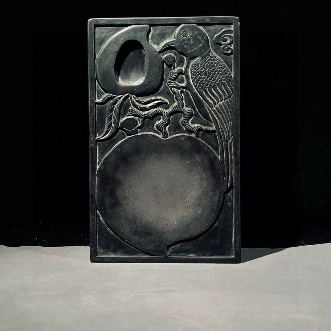 An Exquisite Peach and Bird Pattern Inkstone,With Poem: An Exquisite Peach and Bird Pattern Inkstone,With Poem,Qing Dynasty, China,Liang Shizheng Mark,Size:(Inkstone)8.7inx5.3inx1.2in 桃子鸟纹砚台,带诗文