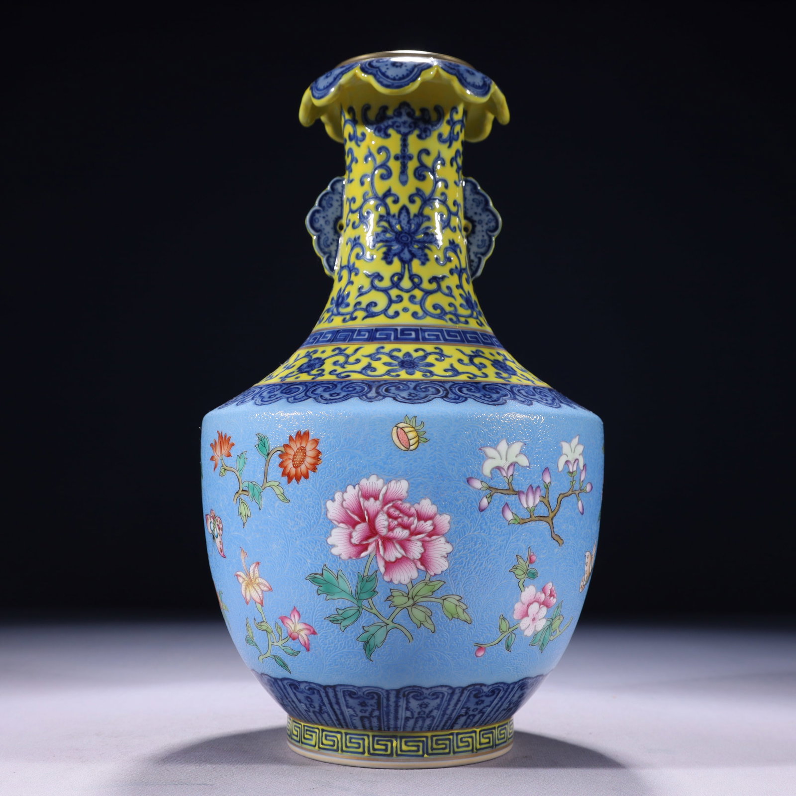 An Exquisite Blue Ground Famille-Rose Painted Gold Flower Pattern Double-Ears Vase: An Exquisite Blue Ground Famille-Rose Painted Gold Flower Pattern Double-Ears Vase,Qing Dynasty,China,Qianlong Six-character Mark,Size:6.7inx12.6in,Weight:1950g