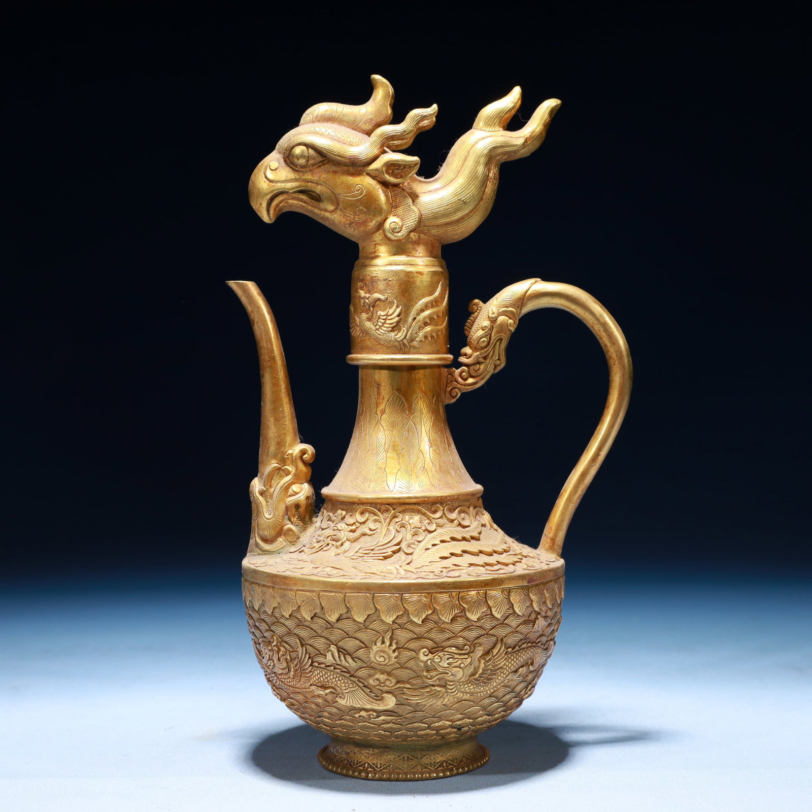 An Exquisite Gilt Bronze Dragon and Phoenix Pattern Ewer: An Exquisite Gilt Bronze Dragon and Phoenix Pattern Ewer,Tang Dynasty,China,Zhenguan Four-character Mark,Size:5.1inx4.3inx9.1in,Weight:1150g 铜鎏金龙凤纹执