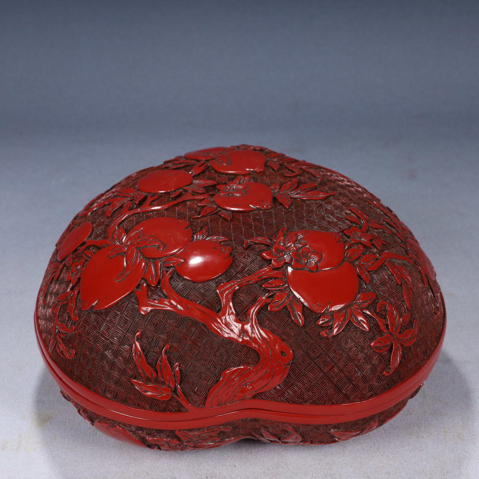An Exquisite Carved Red Lacquer Peach Pattern Peach-Shaped Cover Box: An Exquisite Carved Red Lacquer Peach Pattern Peach-Shaped Cover Box,Qing Dynasty, China,Qianlong Six-character Mark,Size:9.4inx8.7inx4.7in,Weight:1550g 剔红漆桃纹桃