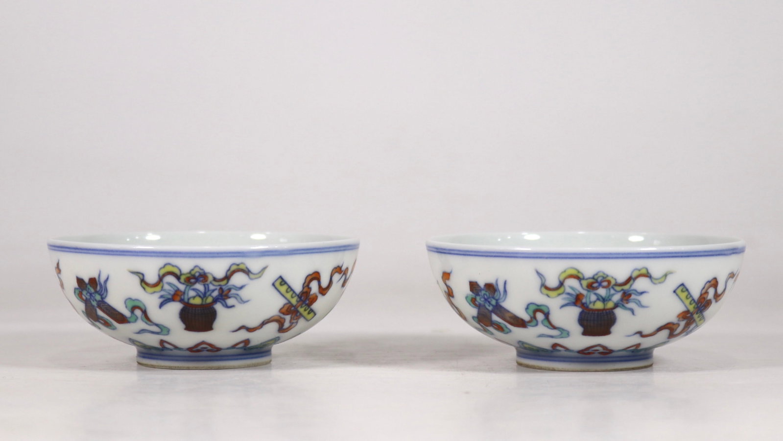 A Pair of Exquisite Blue and White Doucai Eight Treasures Pattern Bowls: A Pair of Exquisite Blue and White Doucai Eight Treasures Pattern Bowls,Qing Dynasty,China,Yongzheng Six-character Mark,Size:1.3inx3.3in一对青花斗彩八宝