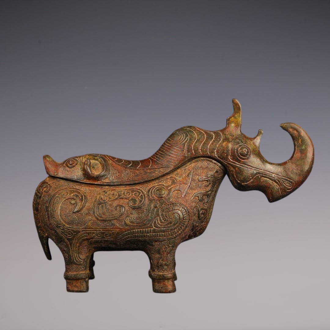 An Archaic Bronze Auspicious Beast Pattern Rhinoceros-Shaped Libation Cup: An Archaic Bronze Auspicious Beast Pattern Rhinoceros-Shaped Libation Cup,W.Zhou