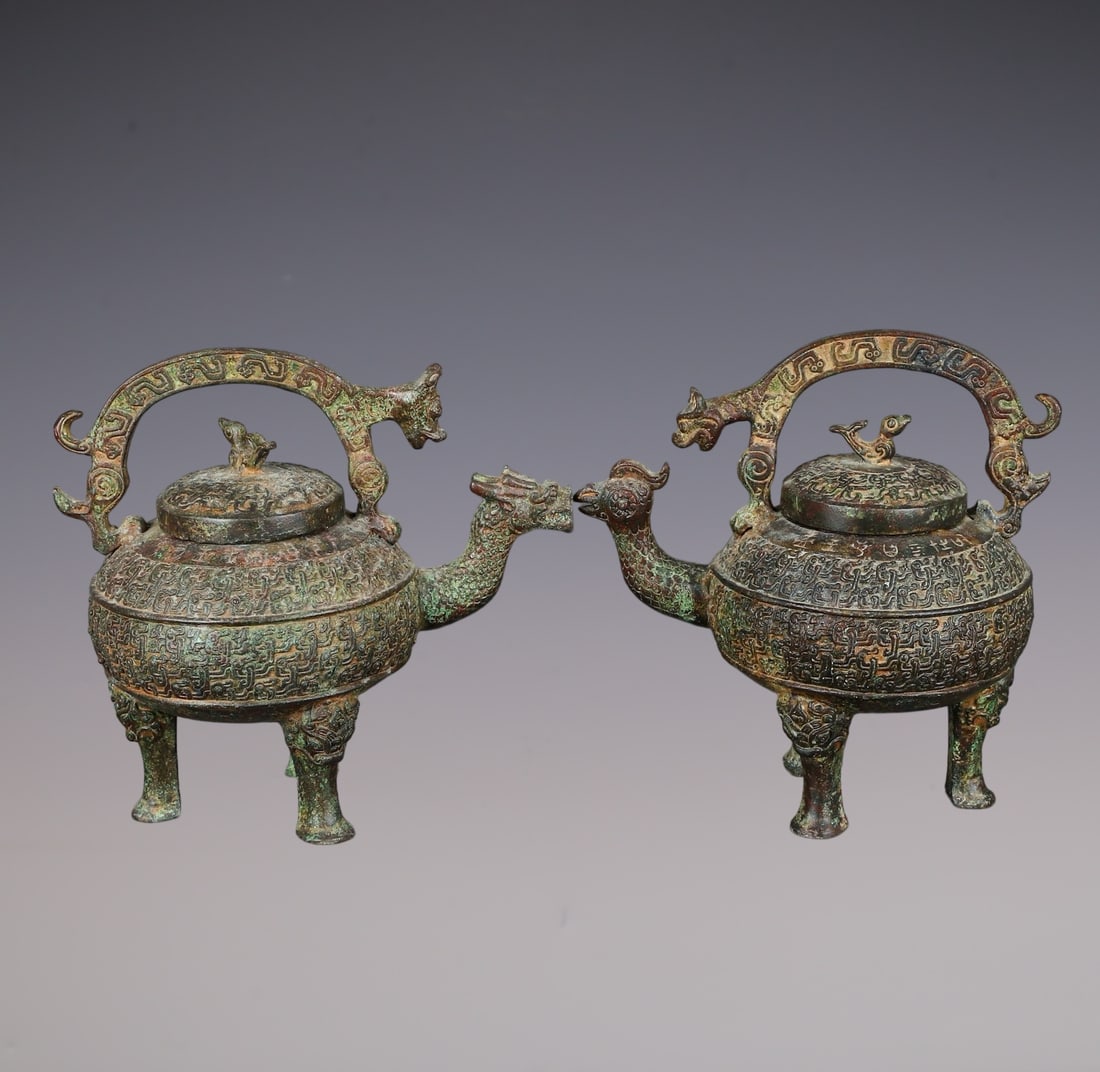A Pair of Archaic Bronze Dragon and Phoenix Pattern Beast Legs Loop-Handled Pots: A Pair of Archaic Bronze Dragon and Phoenix Pattern Beast Legs Loop-Handled Pots,W.Zhou ,China,Size:8.7inx5.3inx8.3in,Total Weight:3620g一对青铜龙凤纹兽