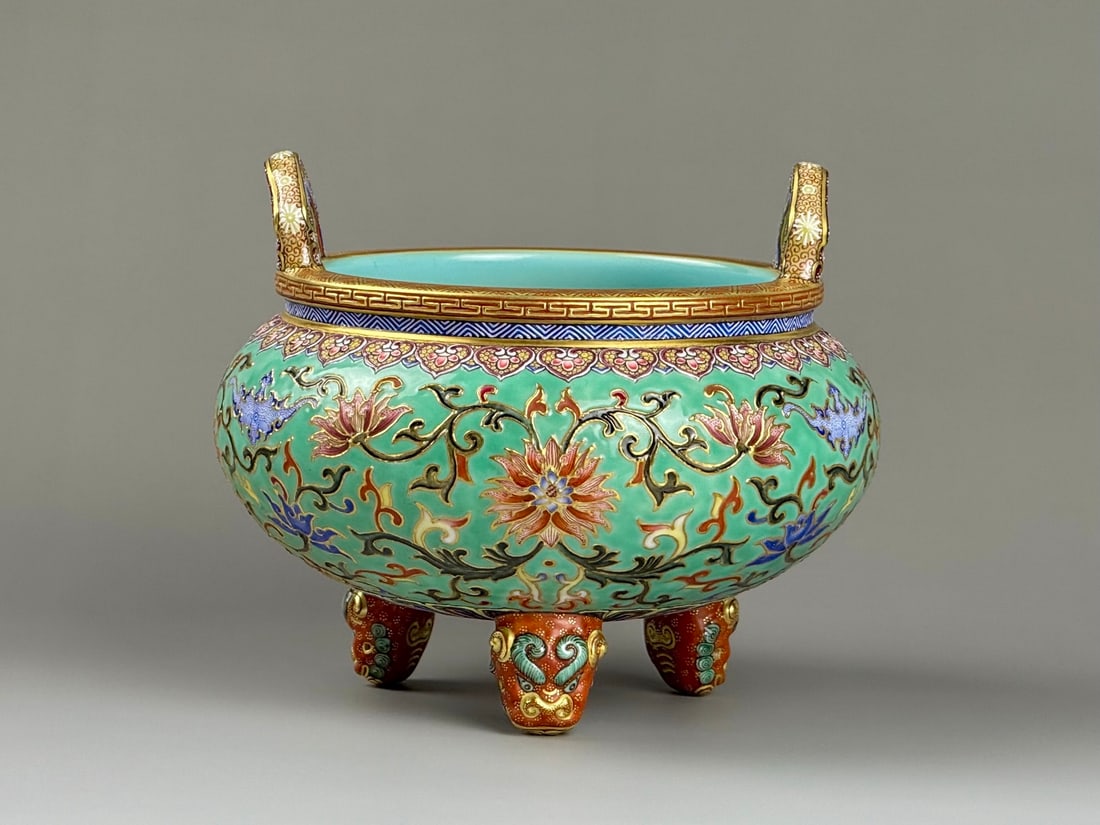 An Exquisite Iron-Red Glazed Turquoise Ground Enamel Painted Gold Lotus and Bats Pattern Double-Ears: An Exquisite Iron-Red Glazed Turquoise Ground Enamel Painted Gold Lotus and Bats Pattern Double-Ears and Tripod Censer,Qing Dynasty,China,Qianlong Six-character Mark,Size:4.8inx5.9inx3.3in矾 