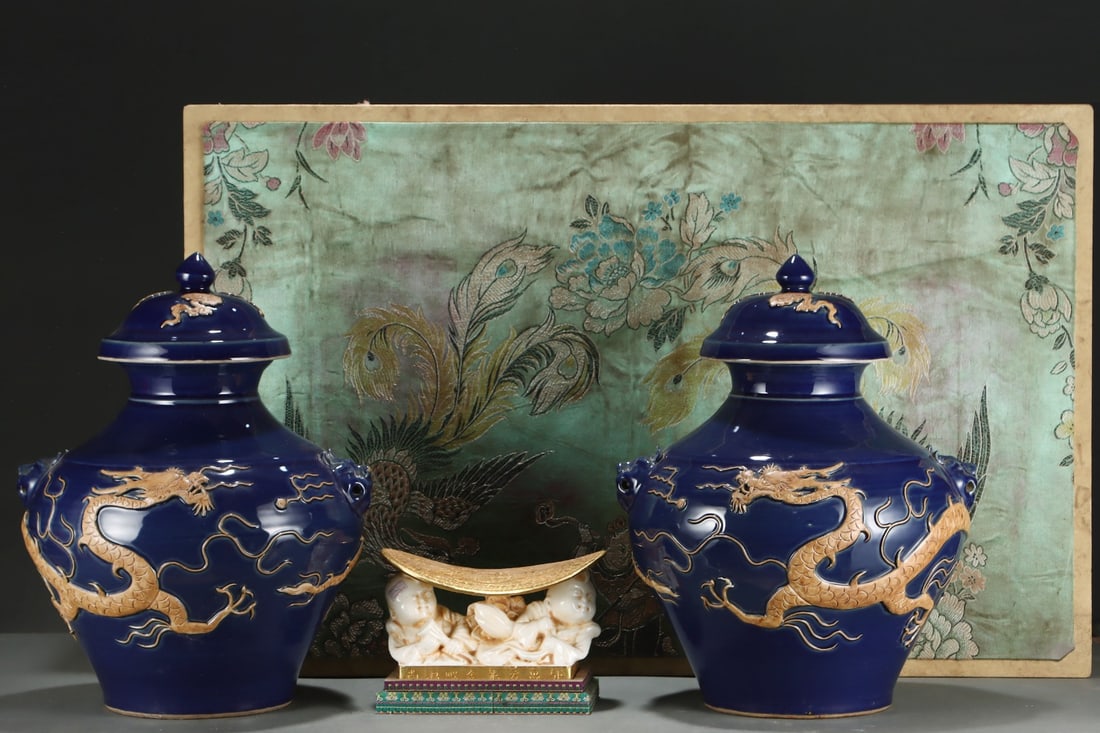 An Exquisite Ji Blue Glazed Dragon Pattern Double-Ears Jar: An Exquisite Ji Blue Glazed Dragon Pattern Double-Ears Jar Yuan Dynasty, China Size:17.7inx14in霁蓝浮雕龙纹狗头盖罐 中国元