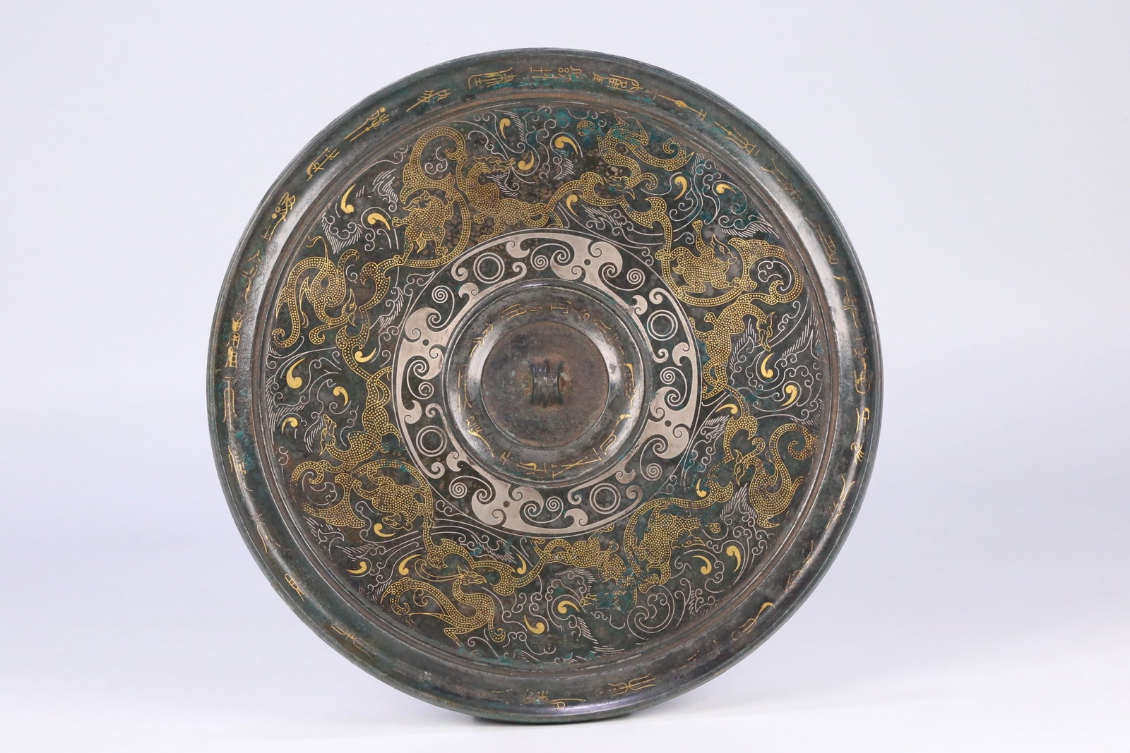 An Exquisite Bronze Inlaid Gold and Silver Auspicious Beast Pattern Mirror: An Exquisite Bronze Inlaid Gold and Silver Auspicious Beast Pattern Mirror,Han Dynasty, ChinaSize:7.7inx0.2in,Weight:683.5g铜错金银瑞兽纹镜子,