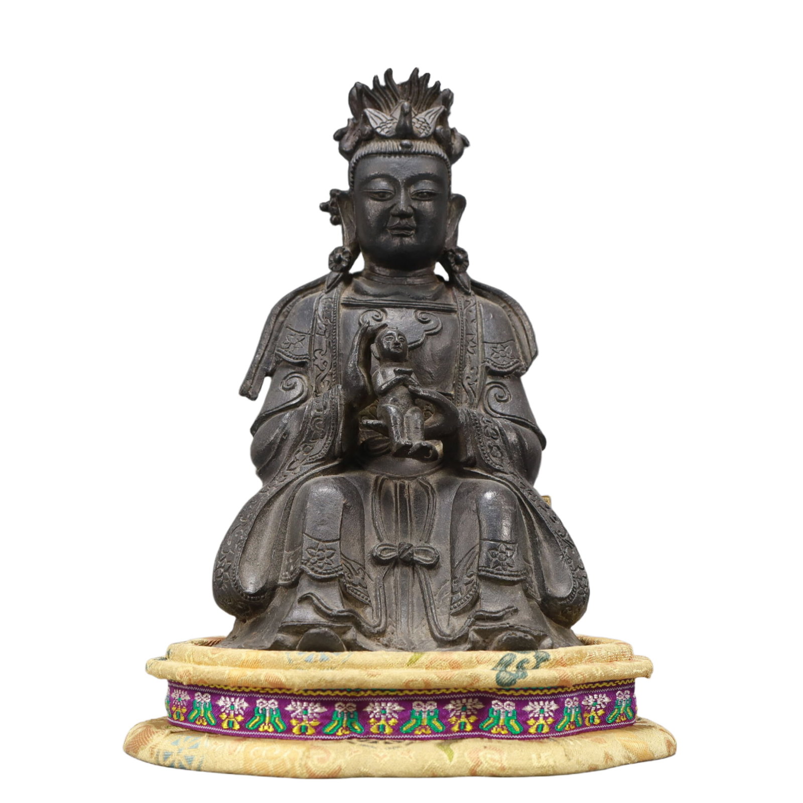 An Excellent Bronze Figure Of Guanyin And A Boy: An Excellent Bronze Figure Of Guanyin And A Boy. Seated with a benevolent expression,body rendered clad in long,flowing robes,the voluminous drapery elegantly cascading in folds. Chinese Ming Dynasty.