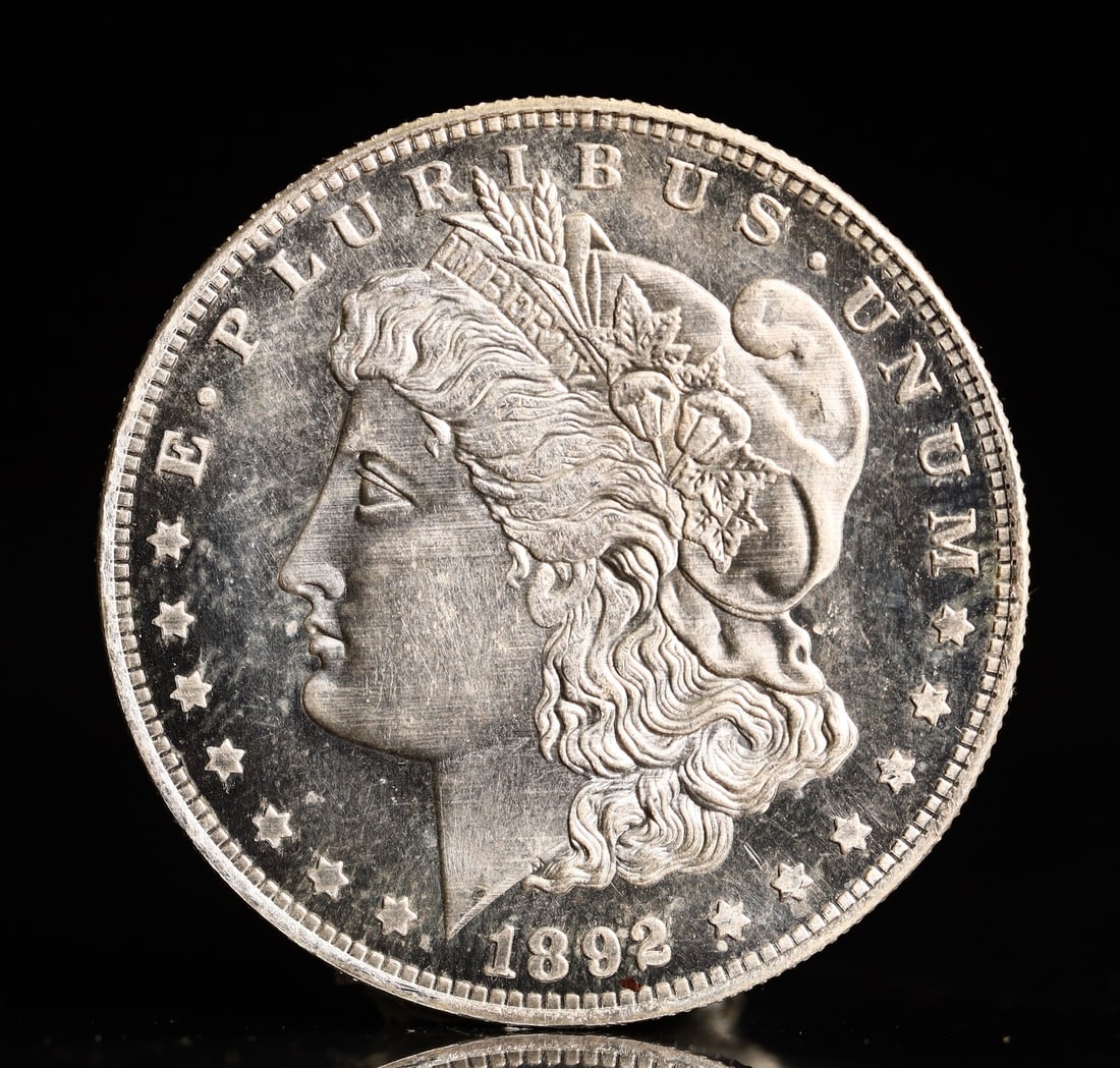 USA Morgan Dollar 1892 Coin: Obv: profile bust with date below and E PLURIBUS UNUM legend and stars around. Rev: eagle with In God we trust above within wreath with UNITED STATES OF AMERICA ONE DOLLAR legend. IN GOD WE TRUST / LI