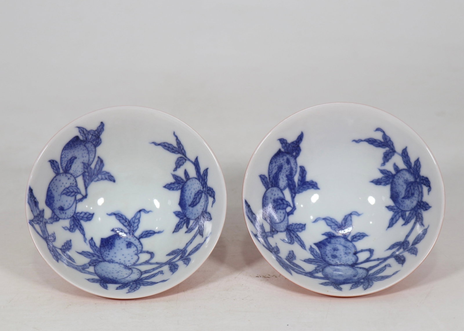An Exquisite Coral Red Glazed Blue and White Peach Pattern Cup: An Exquisite Coral Red Glazed Blue and White Peach Pattern Cup,Qing Dynasty,China,Yongzheng Six-character Mark,Size:3.9inx1.8in