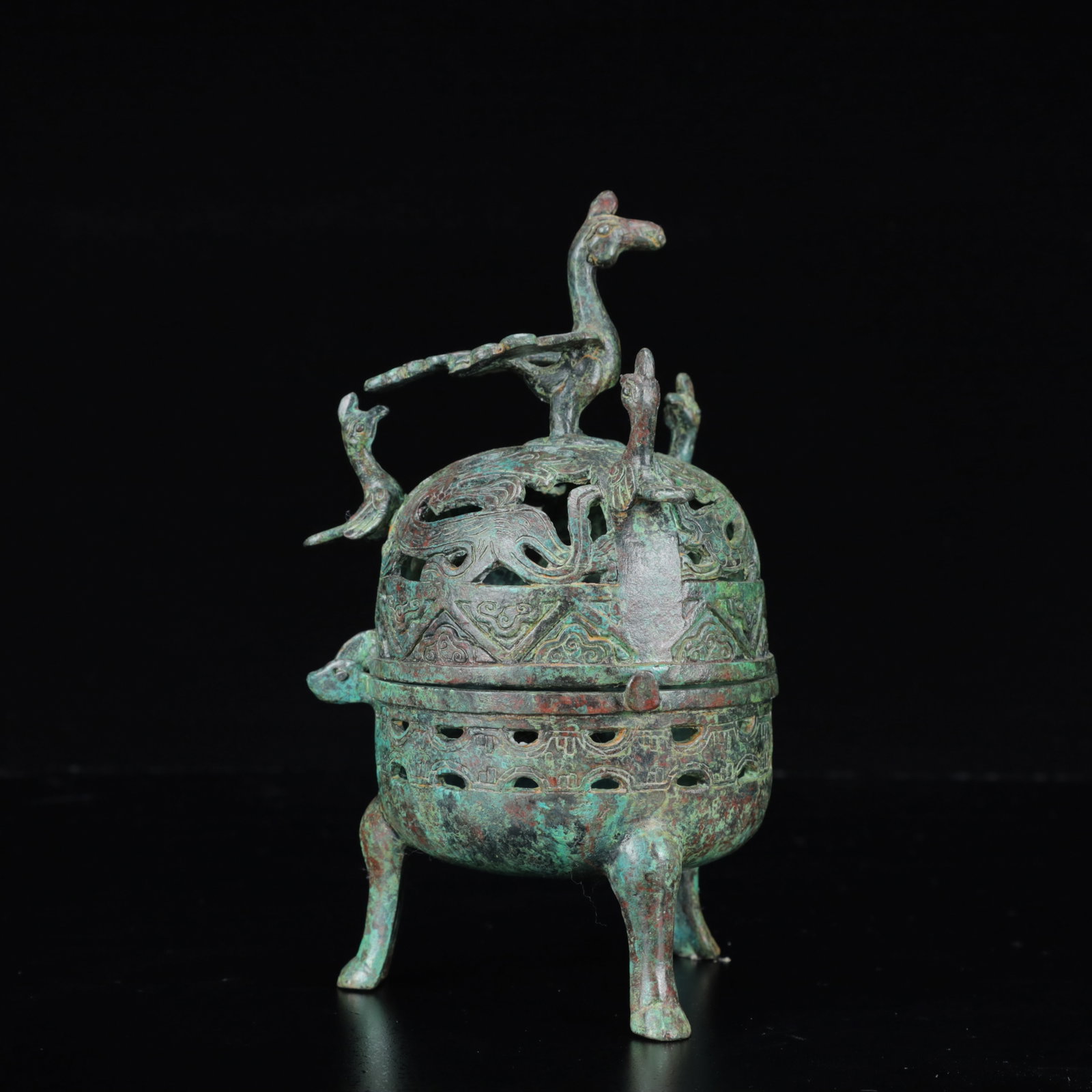 An Archaic Bronze Phoenix Pattern Double-Ears and Tripod Censer: An Archaic Bronze Phoenix Pattern Double-Ears and Tripod Censer,the Warring States Period in China,Size:4.3inx7.9in,Weight:850g 青铜凤纹双耳三足香