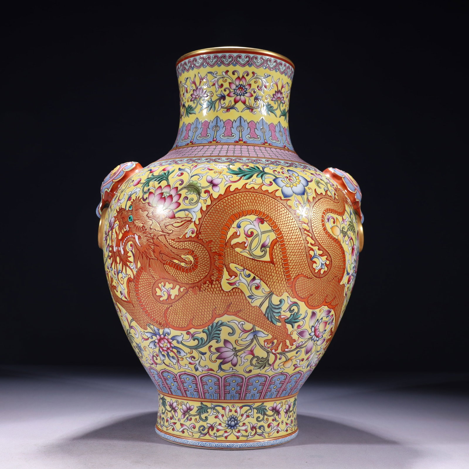 An Exquisite Yellow Ground Famille-Rose Painted Gold Flower and Dragon Pattern Beast-Ears Vase: An Exquisite Yellow Ground Famille-Rose Painted Gold Flower and Dragon Pattern Beast-Ears Vase,Qing Dynasty,China,Qianlong Six-character Mark,Size:10.6inx15.7in,Weight:4200g 黄地粉&#