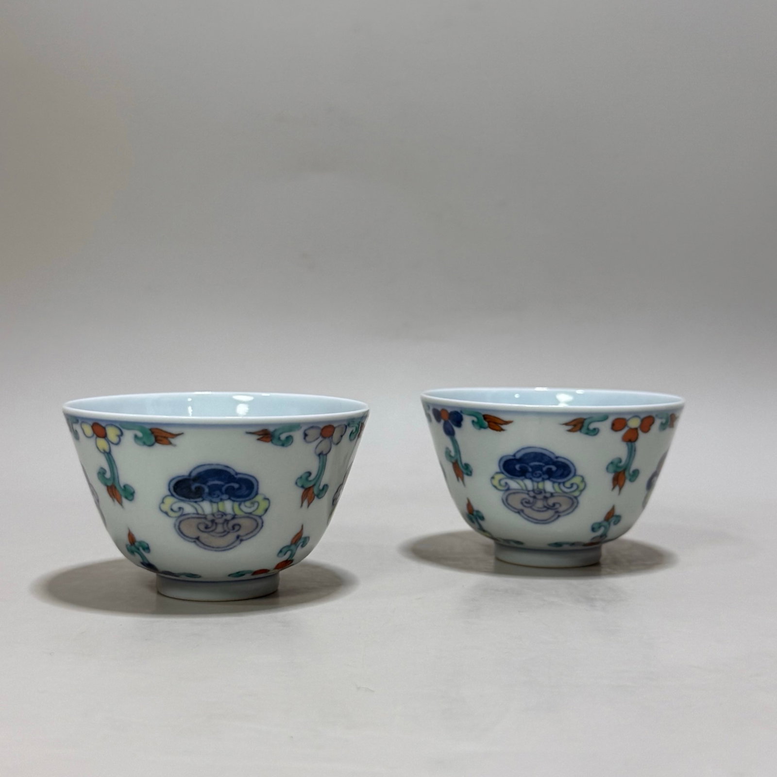 A Pair of Exquisite Blue and White Doucai Flower Pattern Cups: A Pair of Exquisite Blue and White Doucai Flower Pattern Cups,Qing Dynasty,China,Yongzheng Six-character Mark,Size:1.8inx3in