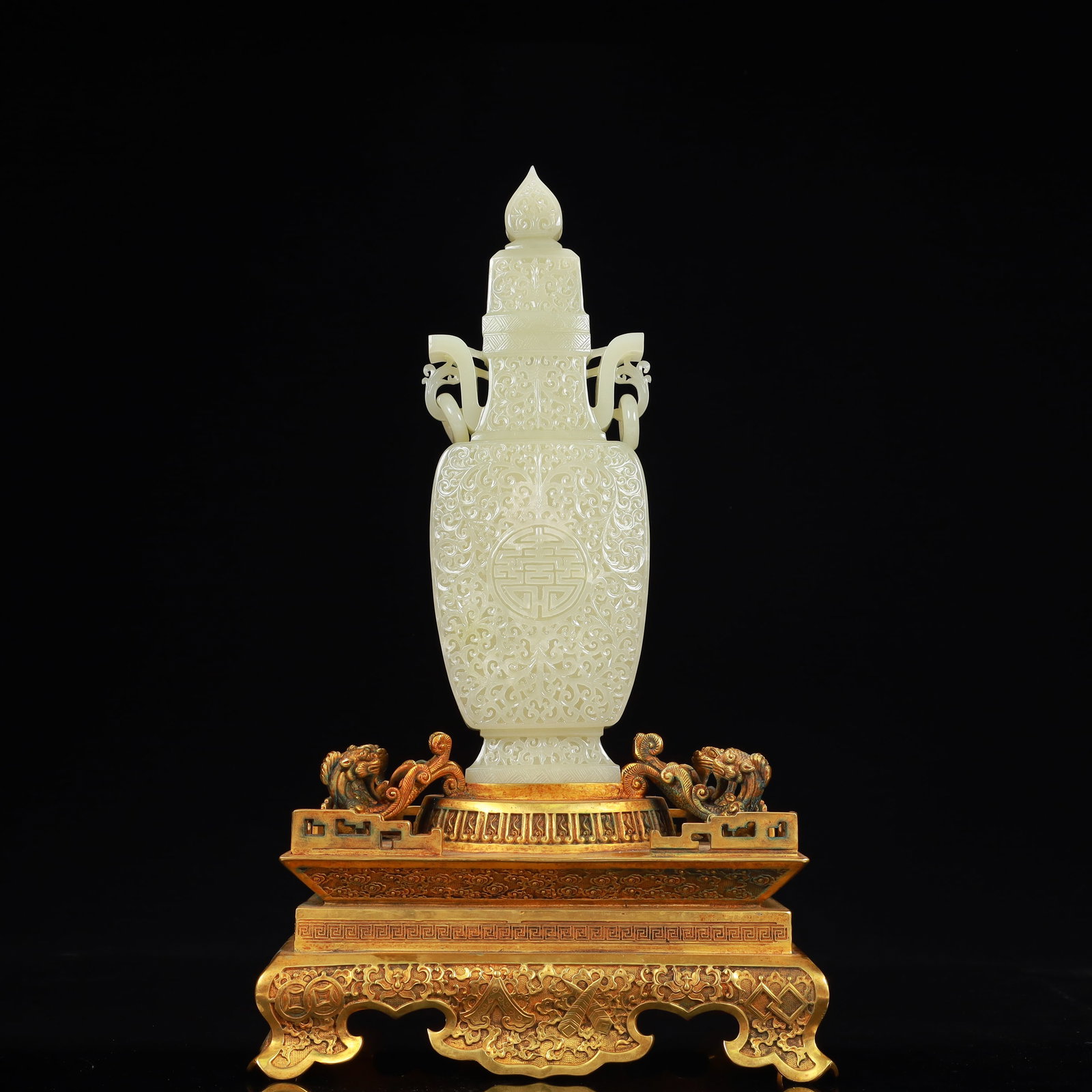 A Rare White Jade Shou-Character Flower Pattern Double-Ears Bottle,With Gilt Bronze Base: A Rare White Jade Shou-Character Flower Pattern Double-Ears Bottle,With Gilt Bronze Base,Qing Dynasty, China,Qianlong Four-character Mark,Size:3.9inx1.6inx12.2in,(Base)9.8inx6.3inx5.9in,Weight:4350g &