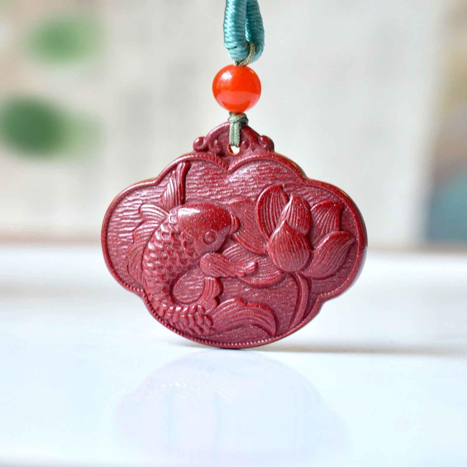 An Exquisite Cinnabar Lotus and Fish Pattern Pendant: An Exquisite Cinnabar Lotus and Fish Pattern Pendant,Size:0.9inx1.9in,Weight:10.46g 朱砂荷花鱼纹挂件
