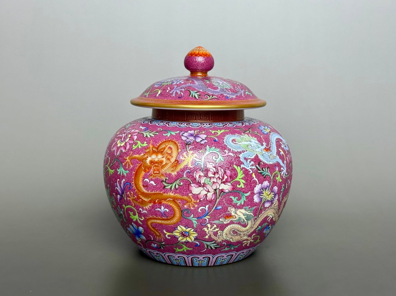 An Exquisite Iron-Red Glazed Ruby Red-Ground Famille-Rose Painted Gold Lotus and Dragon Pattern: An Exquisite Iron-Red Glazed Ruby Red-Ground Famille-Rose Painted Gold Lotus and Dragon Pattern Cover Jar,Qing Dynasty,China,Qianlong Four-character Mark,Size:7.1inx6.3inx3.9in矾红釉