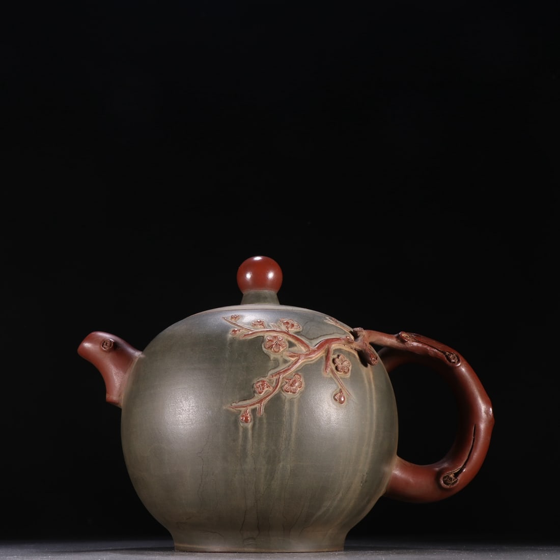An Exquisite Purple Sands Flower Pattern Teapot: An Exquisite Purple Sands Flower Pattern Teapot Qing Dynasty, China Size:8.4inx11.7in紫砂梅花纹茶壶 中国清代 Size:21.4cmx29.8cm