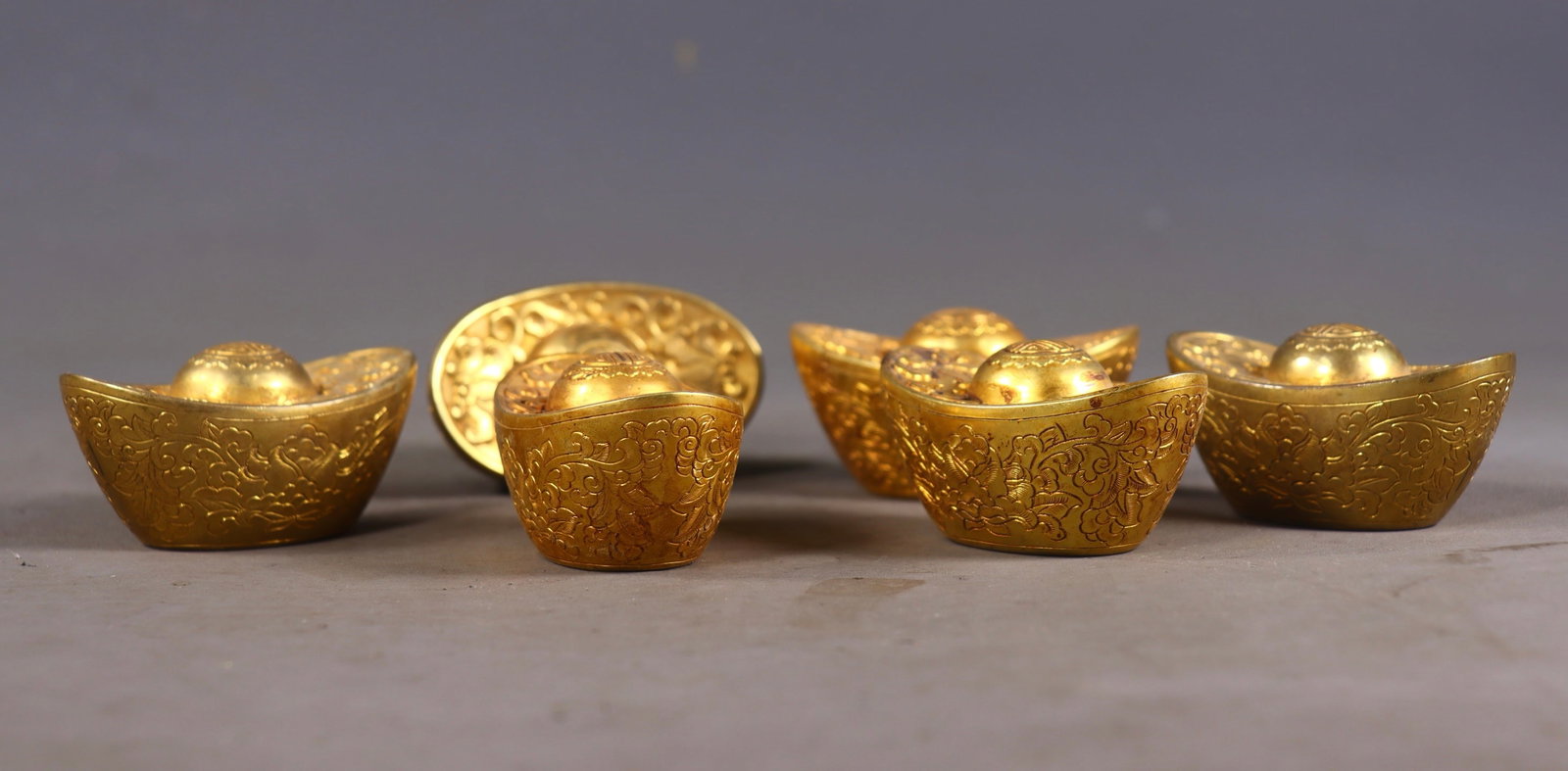 A Set of Fine Gilt Bronze Lotus Pattern Ingots: A Set of Fine Gilt Bronze Lotus Pattern Ingots,Qing Dynasty,China,Size:1.4inx2.6inx1.4in,Total Weight:2034g一套铜鎏金缠枝莲纹元宝,