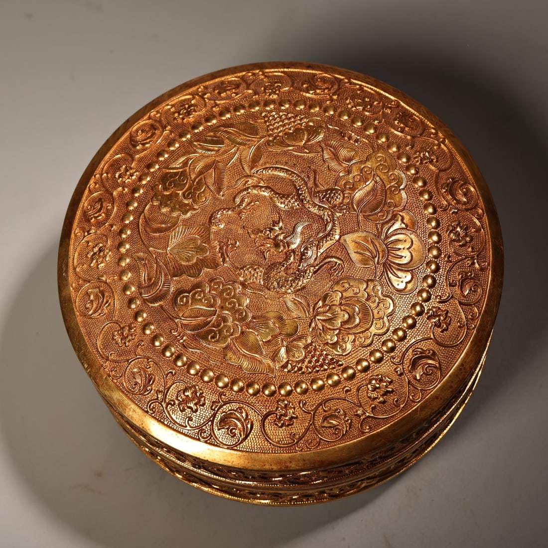 An Exquisite Gilt Bronze Lotus and Dragon Pattern Cover Box: An Exquisite Gilt Bronze Lotus and Dragon Pattern Cover Box,Qing Dynasty, China,With Mark,Size:3inx6.3in,Weight:1590g铜鎏金缠枝莲龙纹盖盒,&#