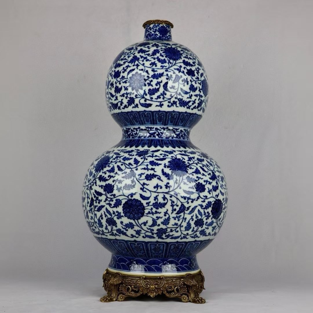 A Huge Blue and White Inlaid Bronze Lotus Pattern Gourd-Shaped Vase: A Huge Blue and White Inlaid Bronze Lotus Pattern Gourd-Shaped Vase,Qing Dynasty,China,Qianlong Six-character Mark,Size:26inx12.6inx9.3in青花镶铜缠枝莲纹