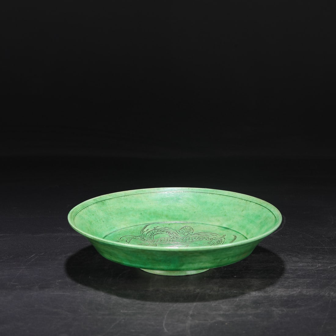 An Exquisite Ding yao Green Glazed Dragon Pattern Plate: An Exquisite Ding yao Green Glazed Dragon Pattern Plate Song Dynasty, China Size:2.2inx9.1in定窑绿釉剔刻龙纹折腰大盘 中