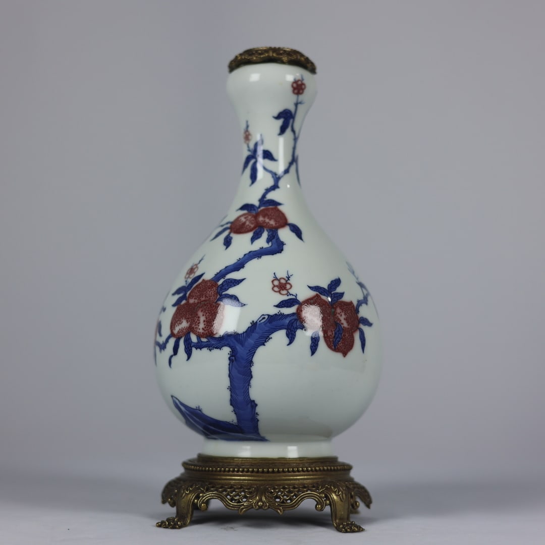 An Exquisite Blue and White Underglaze-Red Inlaid Bronze Bats and Peach Pattern Vase: An Exquisite Blue and White Underglaze-Red Inlaid Bronze Bats and Peach Pattern Vase,Qing Dynasty,China,Kangxi Six-character Mark,Size:10.2inx4.7inx4.3in青花釉里红镶