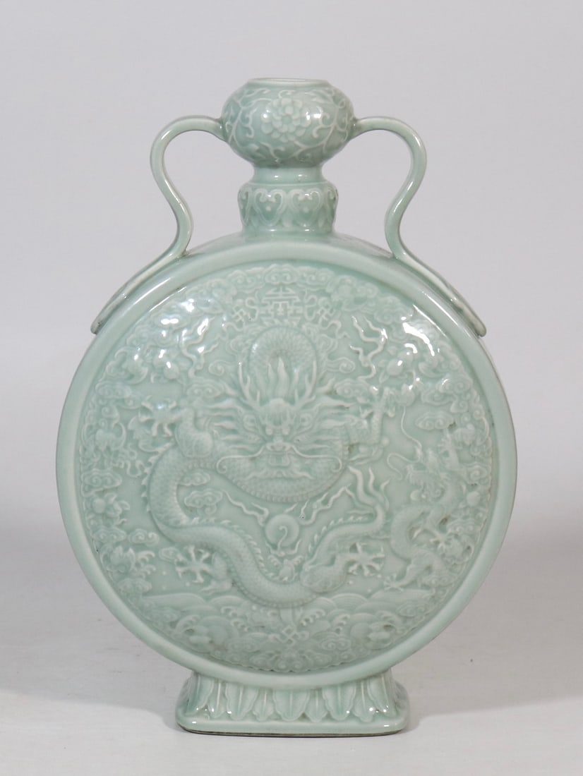 A Rare Celadon Glazed Seawater,Auspicious Cloud and Dragon Pattern Double-Ears Vase: A Rare Celadon Glazed Seawater,Auspicious Cloud and Dragon Pattern Double-Ears Vase,Qing Dynasty,China,Qianlong Six-character Mark,Size:13.6inx9.4in青釉海水祥云(