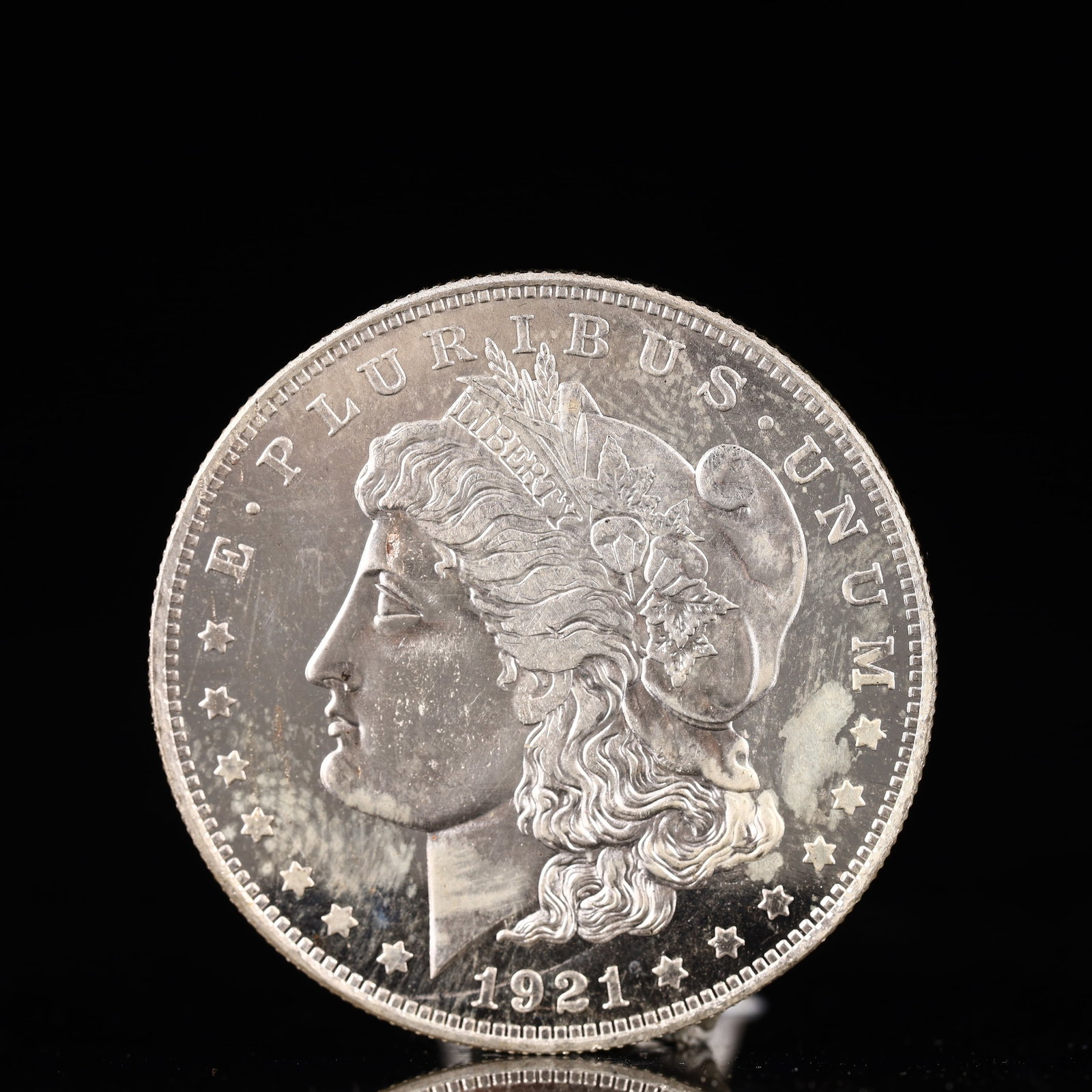 USA Morgan Dollar 1921 Coin: Obv: profile bust with date below and E PLURIBUS UNUM legend and stars around. Rev: eagle with In God we trust above within wreath with UNITED STATES OF AMERICA ONE DOLLAR legend. IN GOD WE TRUST / LI