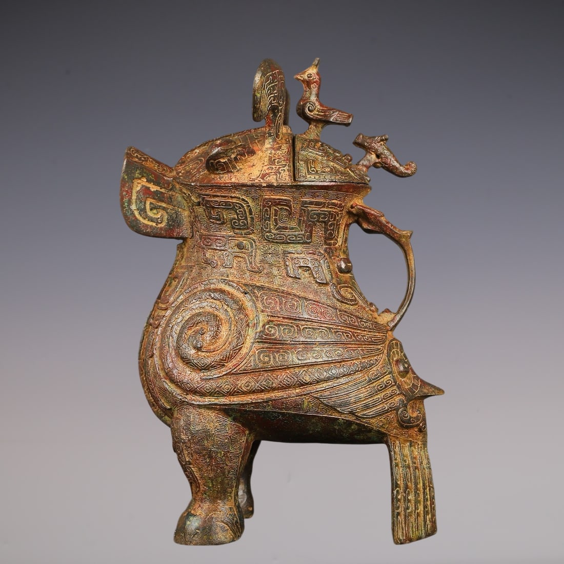 An Archaic Bronze Beast-Face Pattern Bird-Shaped Vase: An Archaic Bronze Beast-Face Pattern Bird-Shaped Vase,W.Zhou ,China,Size:7.5inx10.2in,Weight:2400g青铜兽面纹鸟形瓶,中国西周ą
