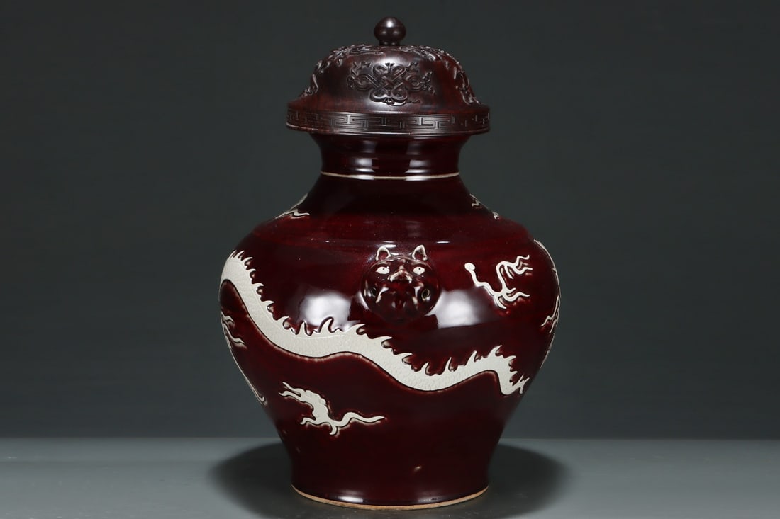 An Exquisite Ji Red Glazed Dragon Pattern Double-Ears Jar: An Exquisite Ji Red Glazed Dragon Pattern Double-Ears Jar Yuan Dynasty, China Size:17.9inx14in霁红釉白龙纹兽头罐 中国元代 