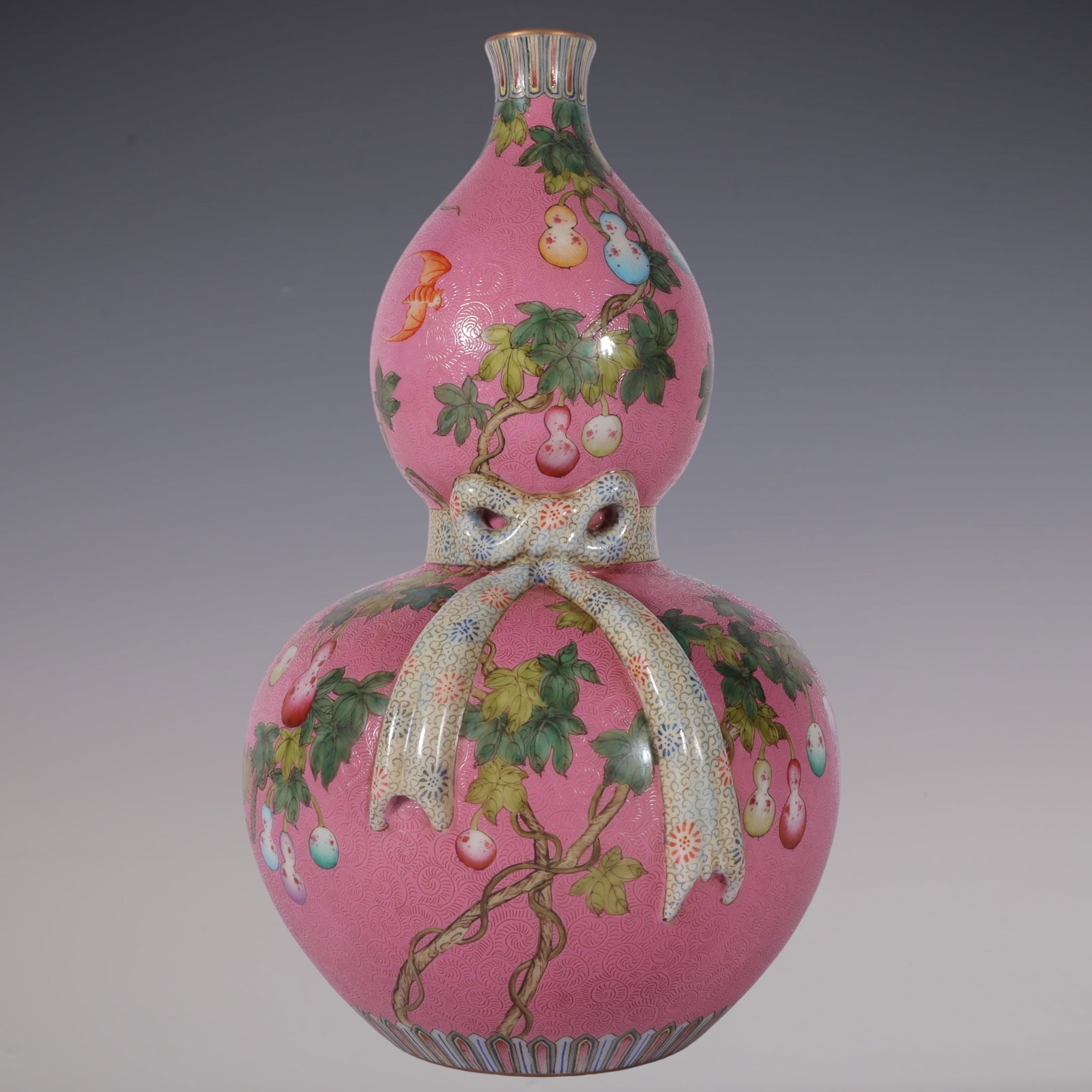 An Exquisite Famille-Rose Flower and Fruit Pattern Gourd-Shaped Vase: An Exquisite Famille-Rose Flower and Fruit Pattern Gourd-Shaped Vase Qing Dynasty, China Qianlong Six-character Mark Size:10.9inx6.1in粉彩粉地轧道葫芦&#