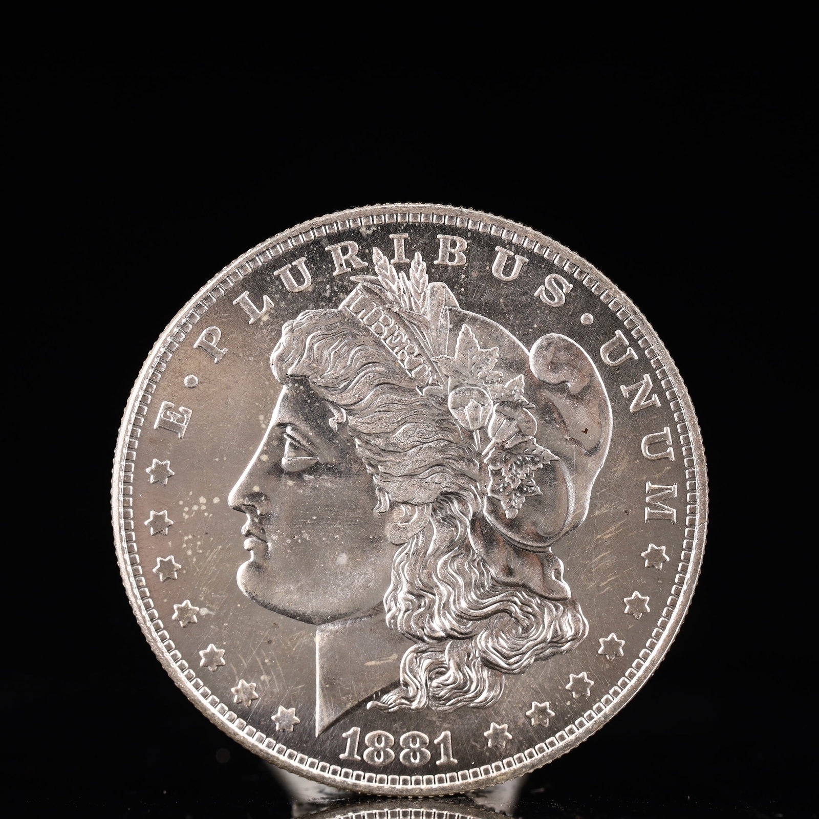 USA Morgan Dollar 1881 Coin: Obv: profile bust with date below and E PLURIBUS UNUM legend and stars around. Rev: eagle with In God we trust above within wreath with UNITED STATES OF AMERICA ONE DOLLAR legend. IN GOD WE TRUST /