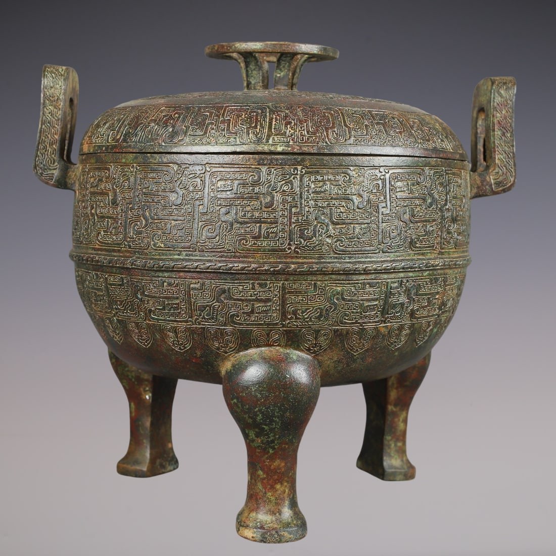 An Archaic Bronze Double-Ears and Tripod Censer,With Inscription: An Archaic Bronze Double-Ears and Tripod Censer,With Inscription,Han Dynasty,China,Size:11.4inx9.1inx10.6in,Weight:5650g青铜双耳三足香炉,带铭