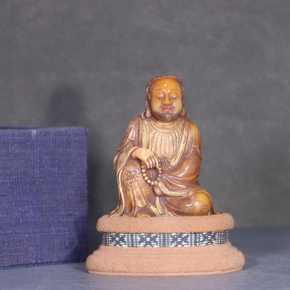 An Exquisite Tianhuang Stone Arhat Ornament: An Exquisite Tianhuang Stone Arhat Ornament,Republic of China,With Mark,Size:3.4inx2.7in,Weight:213g 田黄石雕罗汉摆件,民国,带款