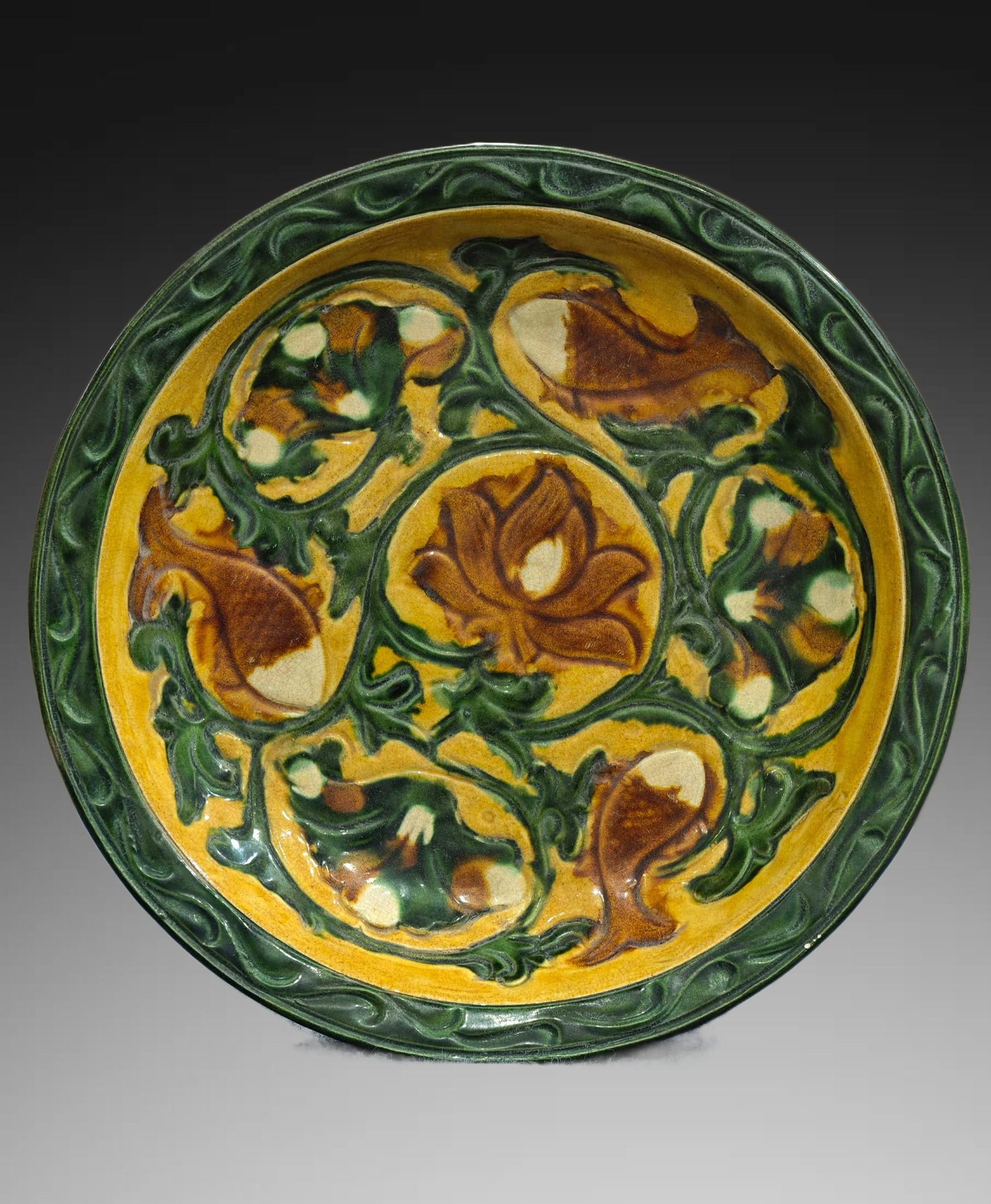 An Exquisite Tang Tri-Color Glazed Pottery Lotus Pattern Brush Washer: An Exquisite Tang Tri-Color Glazed Pottery Lotus Pattern Brush Washer,Tang Dynasty, China,Size: 3.5mx8.7in 唐三彩缠枝莲纹笔洗,中国