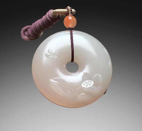 An Exquisite Hotan Jade Lotus Pattern Safety Buckle: An Exquisite Hotan Jade Lotus Pattern Safety Buckle,Qing Dynasty, China,Size:1.8inx0.4in,Weight:40g 和田玉莲纹平安扣,中国清代