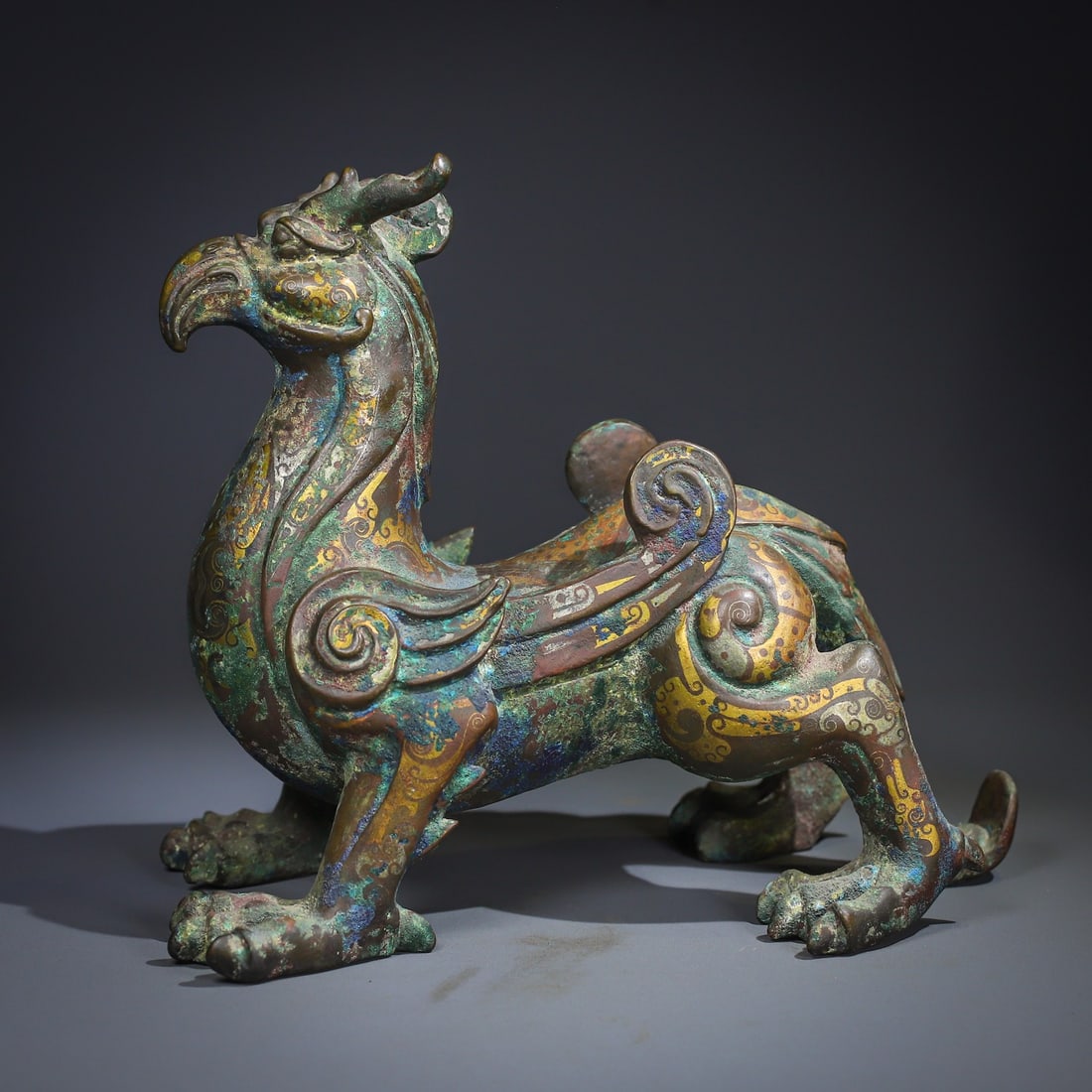 An Exquisite Gold-Inlaid Bronze Auspicious Beast Ornament: An Exquisite Gold-Inlaid Bronze Auspicious Beast Ornament,Han Dynasty, China,Size:9.1inx10.2in ,Weight:5500g 铜错金瑞兽摆件,中国汉代
