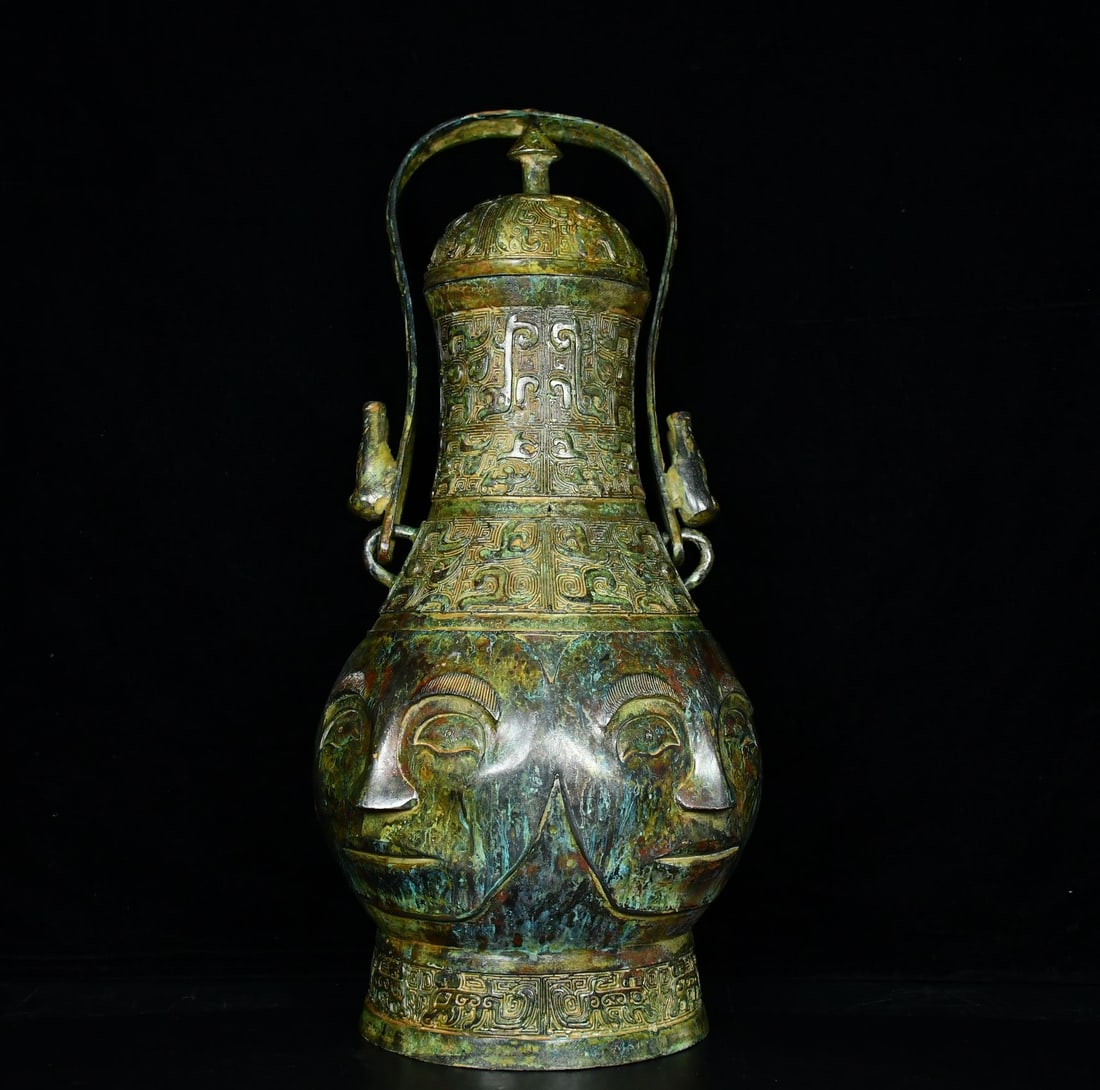 An Archaic Bronze Figure-Face Pattern Loop-Handled Pot,With Inscription: An Archaic Bronze Figure-Face Pattern Loop-Handled Pot,With Inscription,Qing Dynasty, China,Size:19.7inx9.1in,Weight:6300g青铜人面纹提梁壶,带Ž