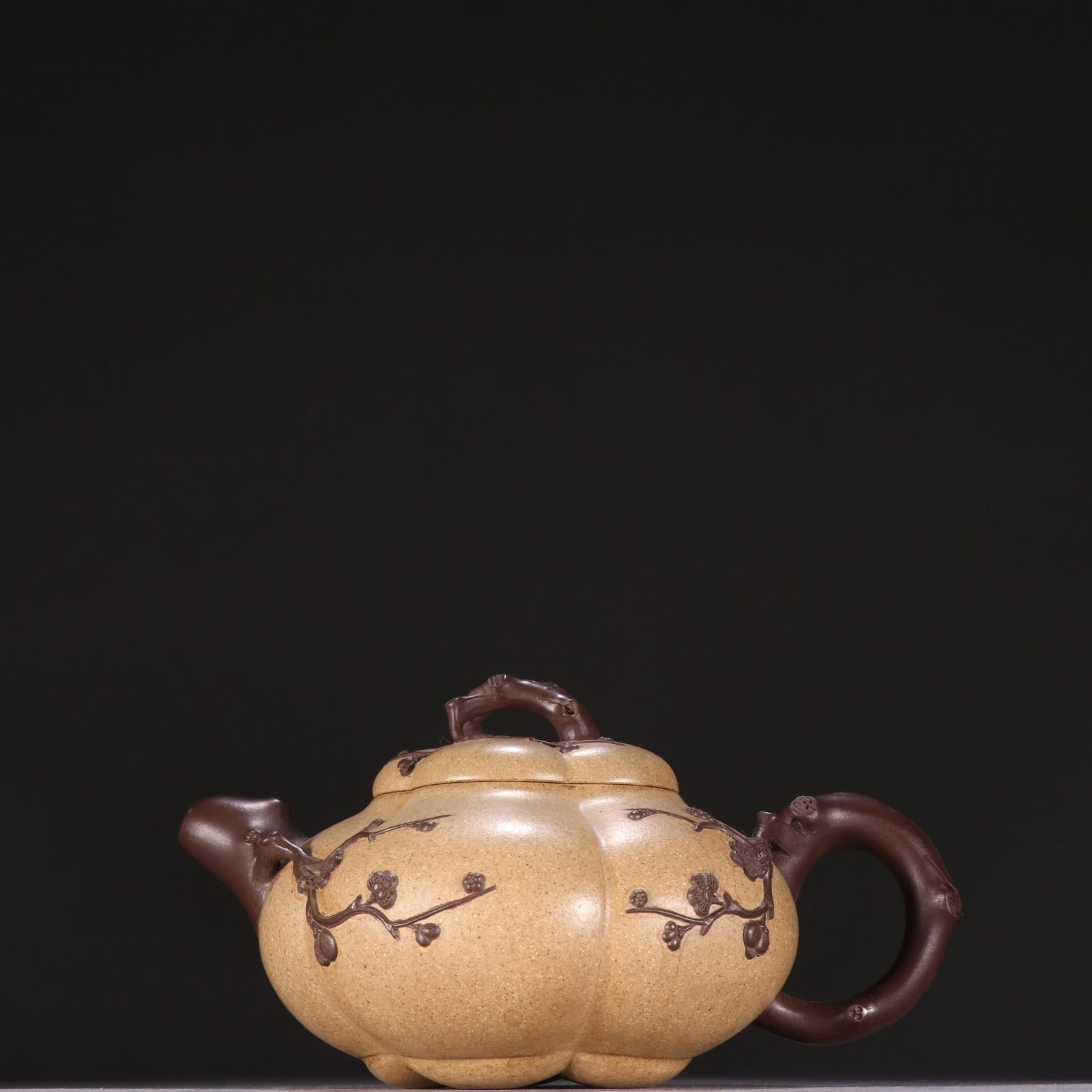 An Exquisite Purple Sands Plum Blossom Pattern Teapot: An Exquisite Purple Sands Plum Blossom Pattern Teapot,Qing Dynasty,China,With Mark,Size:3.8inx6.9in紫砂梅花纹茶壶,中国清代,带