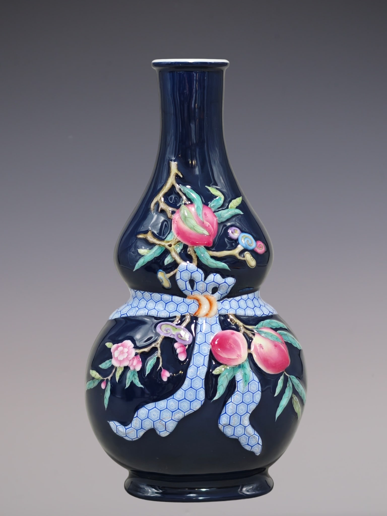 An Exquisite Enamel Ji Blue Glazed Flower and Fruit Pattern Gourd-Shaped Vase: An Exquisite Enamel Ji Blue Glazed Flower and Fruit Pattern Gourd-Shaped Vase,Qing Dynasty, China,Qianlong Four-character Mark,Size:10.6inx5.9in珐琅彩霁蓝釉花