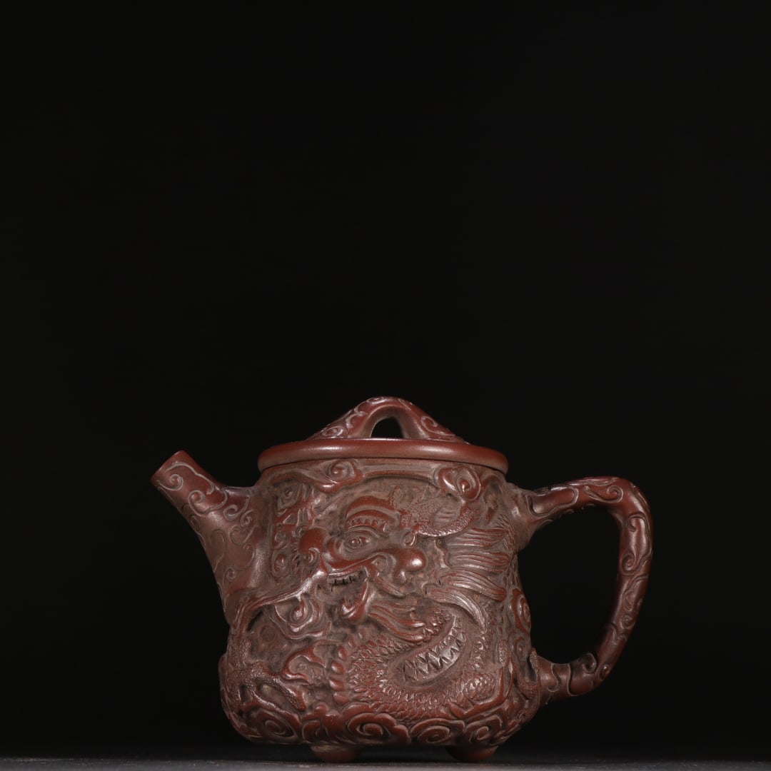 An Exquisite Purple Sands Auspicious Cloud,Fish and Dragon Pattern Tripod Teapot: An Exquisite Purple Sands Auspicious Cloud,Fish and Dragon Pattern Tripod Teapot,Qing Dynasty,China,With Mark,Size:4.6inx5.7in紫砂祥云鱼龙纹三足&#