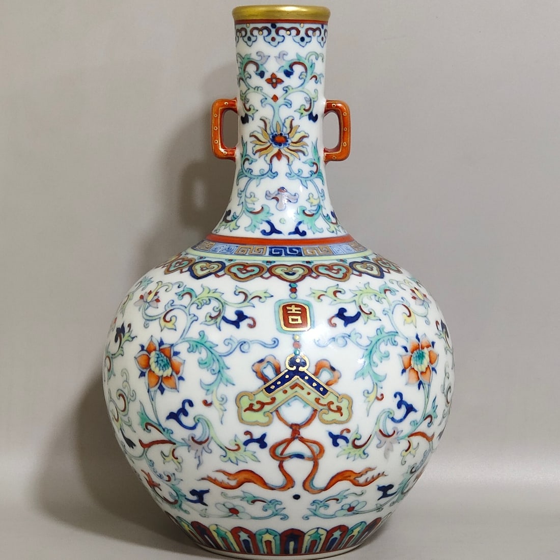 An Exquisite Small Celestial Sphere Vase With Doucai Painting,Gilding Decoration,Treasure Lotus: An Exquisite Small Celestial Sphere Vase With Doucai Painting,Gilding Decoration,Treasure Lotus Patterns And Auspicious Longevity Motifs,Qing Dynasty,China,Qianlong Six-character