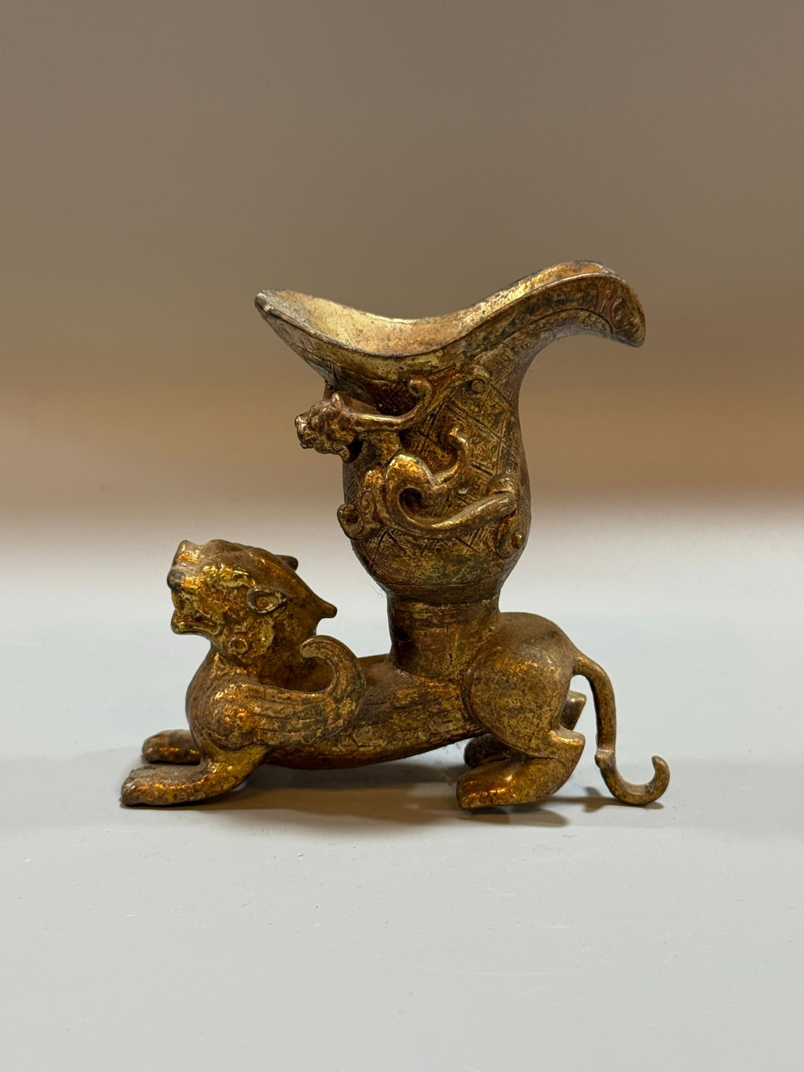 An Exquisite Gilt Bronze Jue Cup With Auspicious Beast Carvings: An Exquisite Gilt Bronze Jue Cup With Auspicious Beast Carvings,China,Qing Dynasty,Dimensions:3.9inx3.9in,Weight:519g,铜鎏金瑞兽爵杯,中国清&