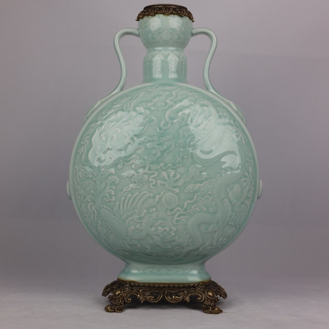 An Exquisite Light Celadon Glaze Moon Flask With Copper Border,Hidden Carved Dragon Pattern: An Exquisite Light Celadon Glaze Moon Flask With Copper Border,Hidden Carved Dragon Pattern,China Qing Dynasty,Six-Character Qianlong Mark,Dimensions:17.3inx6.7in,粉青釉暗Ƃ