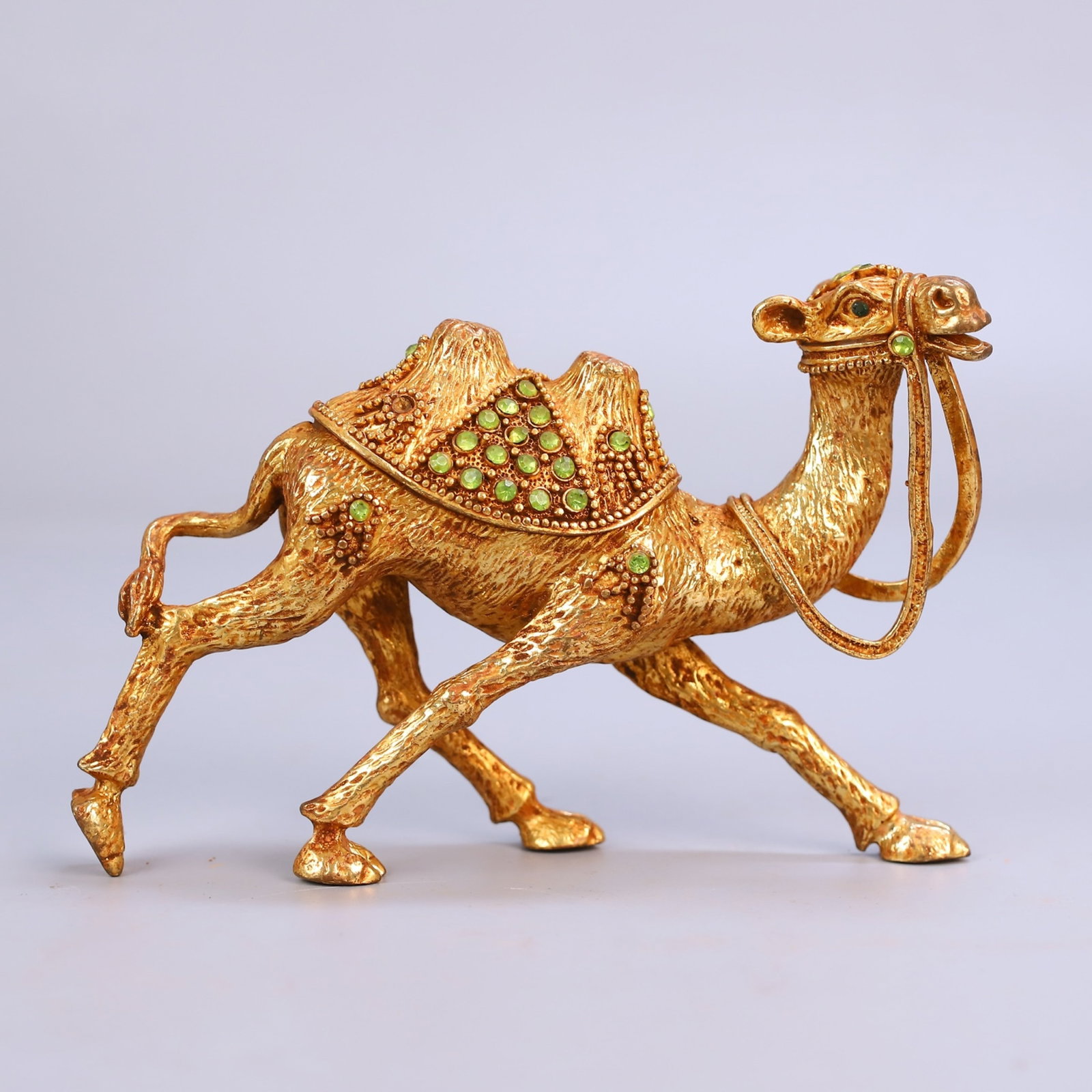 An Exquisite Gilt Bronze Bactrian Camel Ornament Inlaid With Gemstones: An Exquisite Gilt Bronze Bactrian Camel Ornament Inlaid With Gemstones,China,Qing Dynasty,Dimensions:5.9inx4.3in,Weight:288g,铜鎏金镶宝双峰骆驼