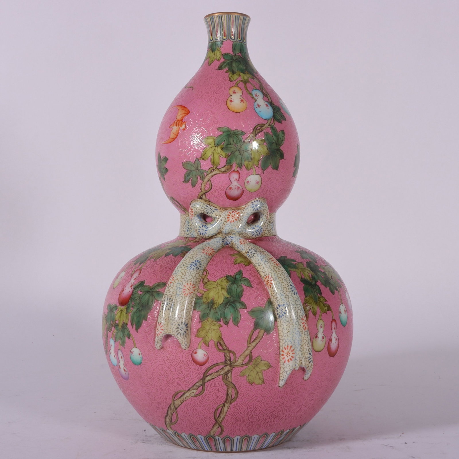 A Fine Famille Rose Pink Ground Graved Gourd Vase with Encircling Gourd Motif: A Fine Famille Rose Pink Ground Graved Gourd Vase with Encircling Gourd Motif,Qing Dynasty,China,Qianlong Six-character Mark,Size:10.9inx6.1in,粉彩粉地轧道葫&